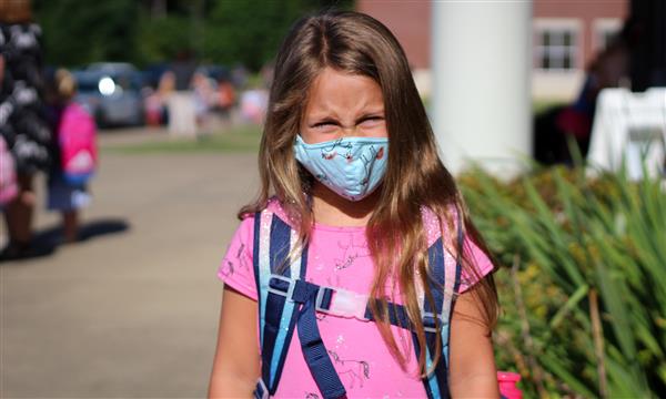 Girl smiles while wearing mask